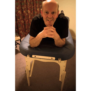 Earthworks Comfort Flat massage table with an adjustable external face cradle and integrated breathe hole plug; a versatile portable table for mobile therapists in Bristol that solves client positioning struggles by offering dual headrest options.