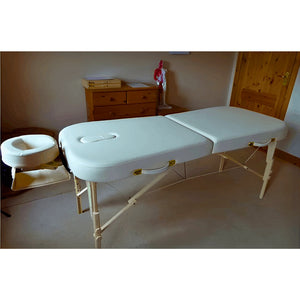 Earthworks Comfort Flat massage table featuring dual-end headrest ports and dense comfort padding; a reliable wooden-frame setup for home treatments in Edinburgh that solves client muscle guarding by fully supporting the shoulders.
