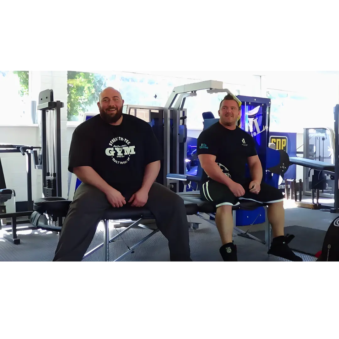 Porta-Lite Delta 2 portable massage table engineered with a heavy-duty aircraft-grade aluminium chassis, stable cable tension system, and a maximum working weight capacity of 500lbs (267kg); shown in a gym environment in Sheffield to solve the risk of structural frame collapse, creaking, or buckling when heavy powerlifters, strongmen, or large bariatric clients sit directly on the couch edge.