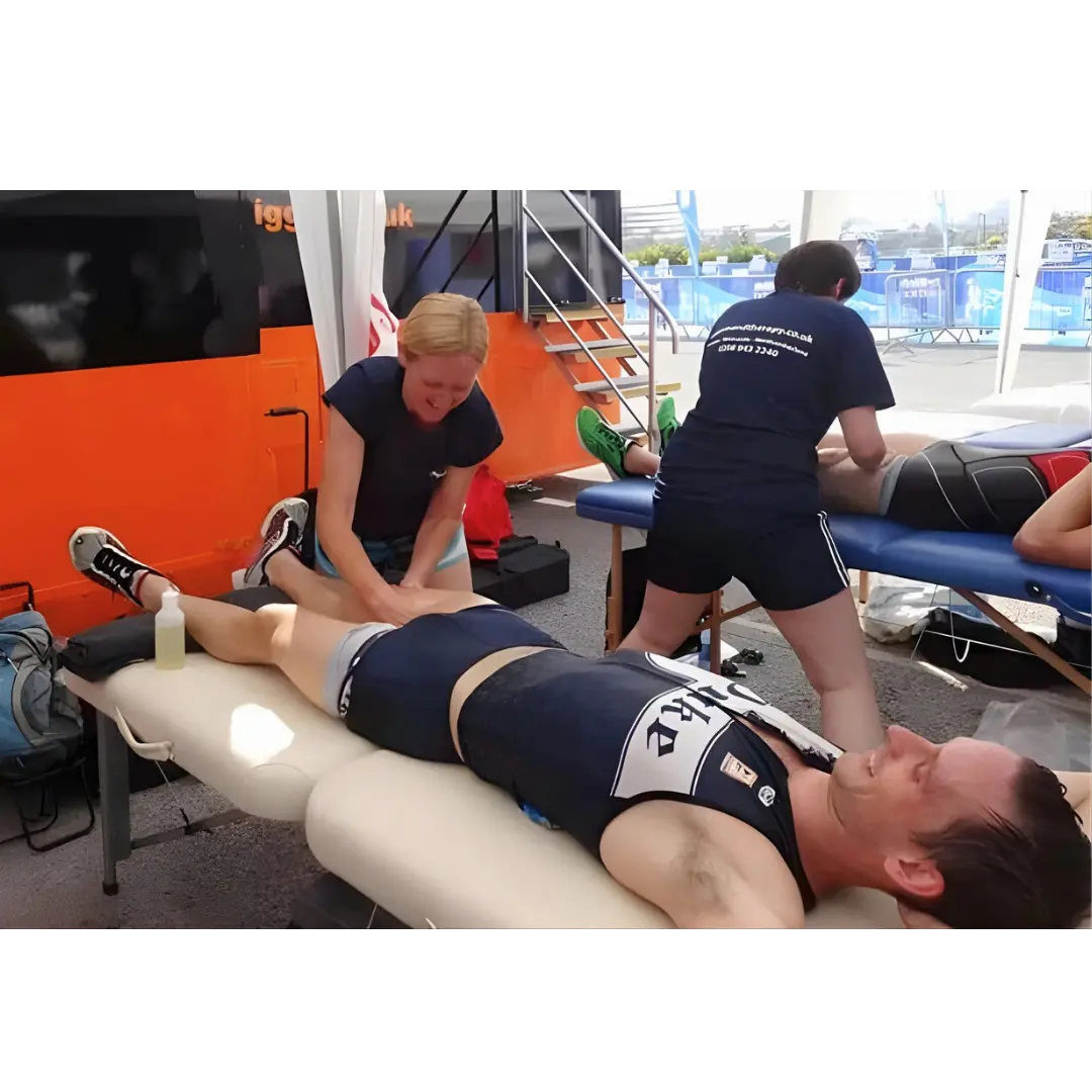 Porta-Lite Delta 2 portable massage table featuring an aircraft-grade aluminium frame, secure cable lock system, and 6.5cm high-density multi-layer foam padding; an essential lightweight sports therapy couch used at an outdoor athletics race in Newcastle to solve the problem of table wobble and frame flexing during high-pressure post-race hamstring flushing and deep tissue bodywork.