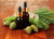 Oil bottles on a wooden table nestled in fir cones
