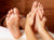 Close up of a massage therapist's hands whilst they massage a client's feet