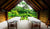 Two empty massage tables overlooking lush tropical forest