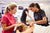 Teacher Helping Student Training To Become Massage Therapist
