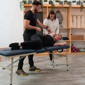 UK therapist using the Advantage Liftback  11.5kg table for side-lying clinical assessment and patient education. 