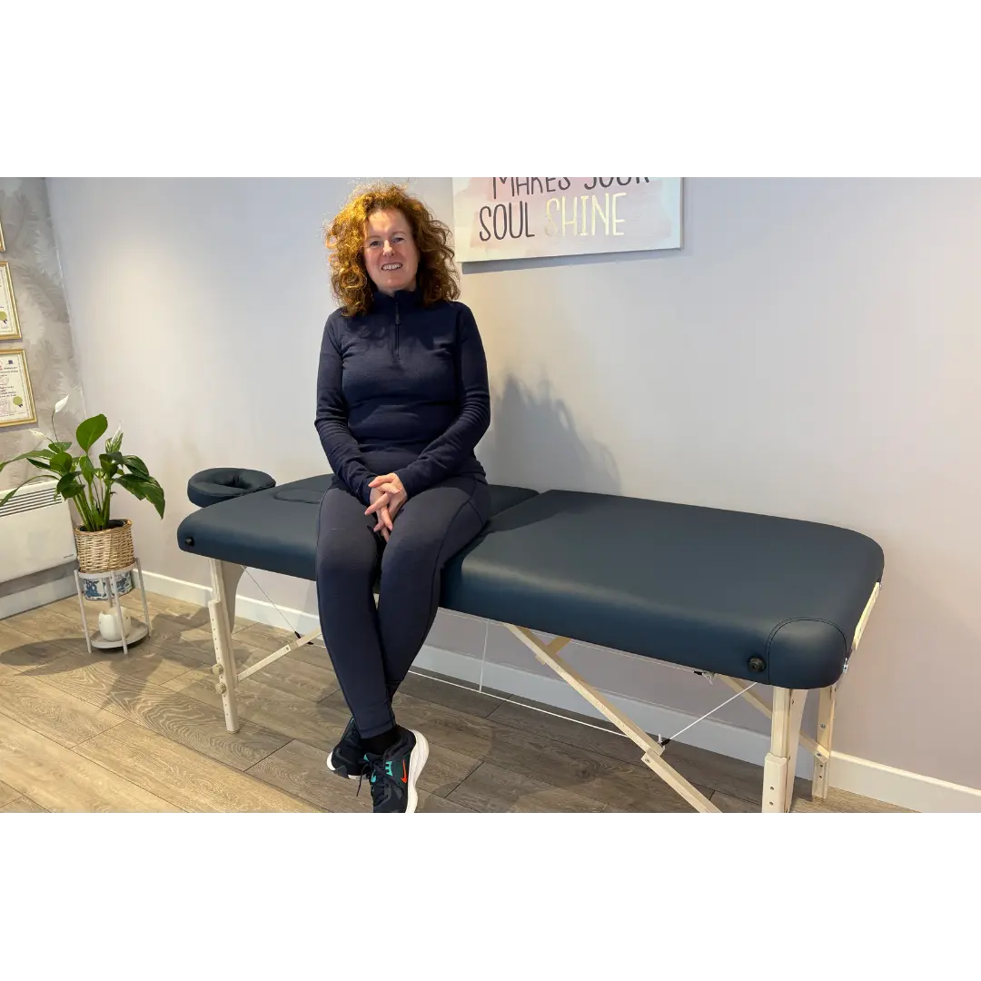 BodyPro Deluxe portable massage table in navy blue highlighting its luxurious 9cm triple-layered high-density foam top and solid German beechwood frame; an ideal treatment bed for a home clinic setup in Coventry that solves the issue of edge-collapsing or client bottoming-out when sitting directly on the side of the couch during intake consultations