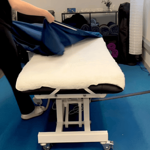Close-up view of the machine washable fleece pad set with headrest cover for massage couch, ideal for holistic therapists, spa technicians, and clinical massage specialists wanting to order fleece massage table pad set online UK from Massage Warehouse in Manchester; includes a 30" x 74" (75 cm x 186 cm) body pad and matching headrest fleece cover anchored by universal elastic straps to add winter warmth and extra cushioning under fitted sheets.
