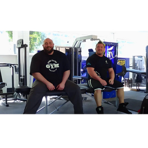 Porta-Lite Delta 2 portable massage table engineered with a heavy-duty aircraft-grade aluminium chassis, stable cable tension system, and a maximum working weight capacity of 500lbs (267kg); shown in a gym environment in Sheffield to solve the risk of structural frame collapse, creaking, or buckling when heavy powerlifters, strongmen, or large bariatric clients sit directly on the couch edge.