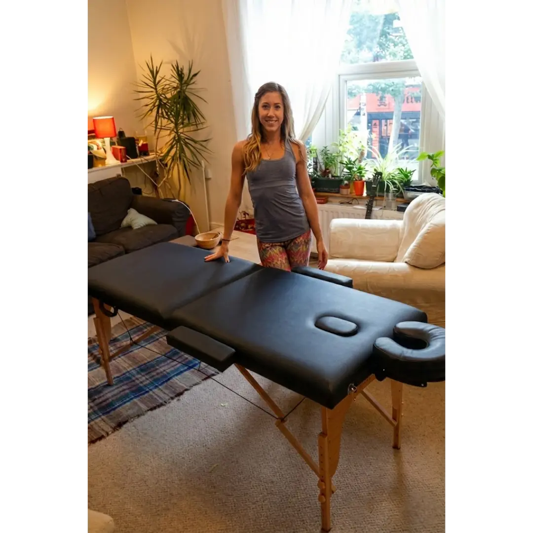 Black Porta-lite Classic massage table featuring 5cm high-density foam and side arm extensions in a studio. Available in London and all over the UK.