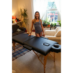 Black Porta-lite Classic massage table featuring 5cm high-density foam and side arm extensions in a studio. Available in London and all over the UK.